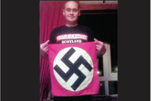 Racist thug James Boyd poses with a Nazi flag