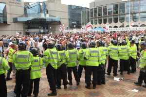 Police watch over a crowd on the day of the protest