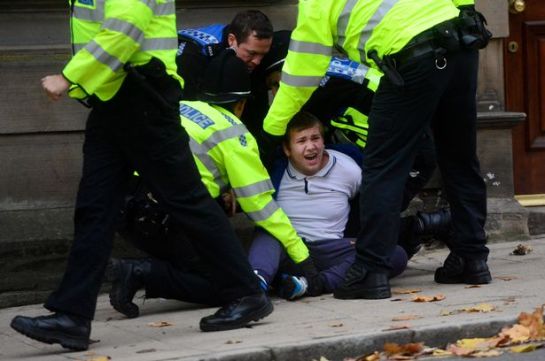 Britain First supporter David Davis is wrestled to the floor by police
