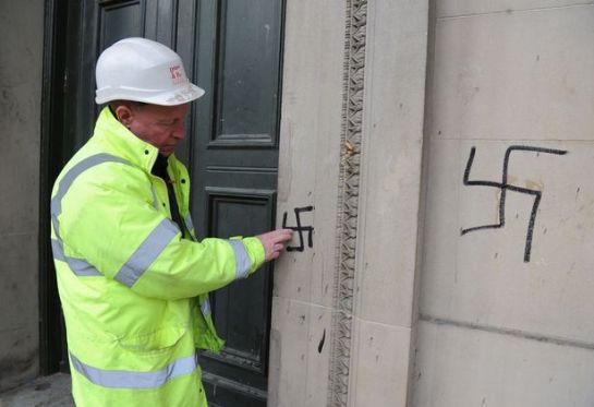 Billy Duggan, from Duggan & Parr Stone Repair Ltd, surveying the graffiti on St George's Hall